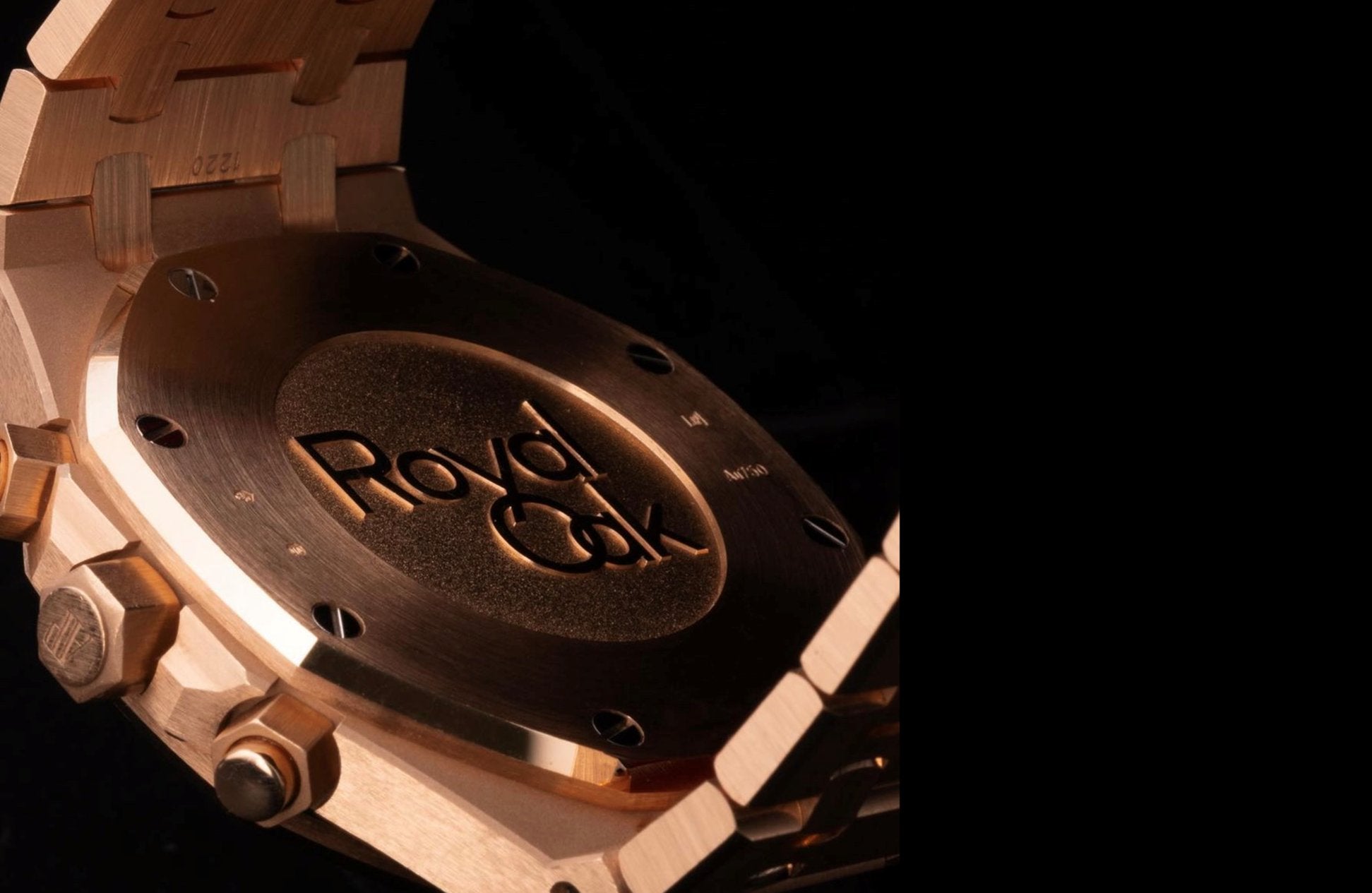Close-up of a Royal Oak watch case back in warm metal tones, showing intricate engravings and screws, conveying luxury and craftsmanship.