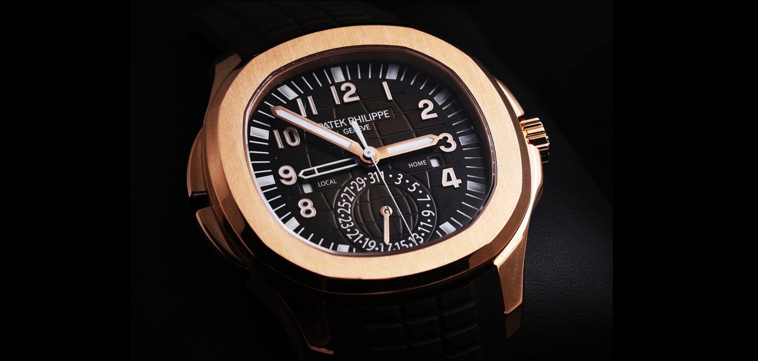 Luxury watch with a gold case, black dial, and bold white numerals. The watch features multiple time zones and a date subdial, exuding elegance.