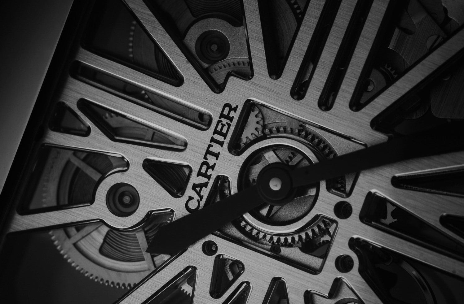 Close-up of a luxury watch face featuring intricate gears and a skeleton design. The word "CARTIER" is visible, highlighting elegance and precision.
