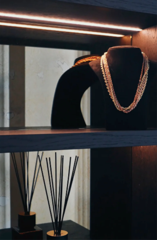 Necklace on a mannequin bust with a modern interior setting