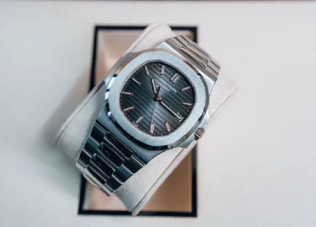 Silver watch with a detailed face on a white background