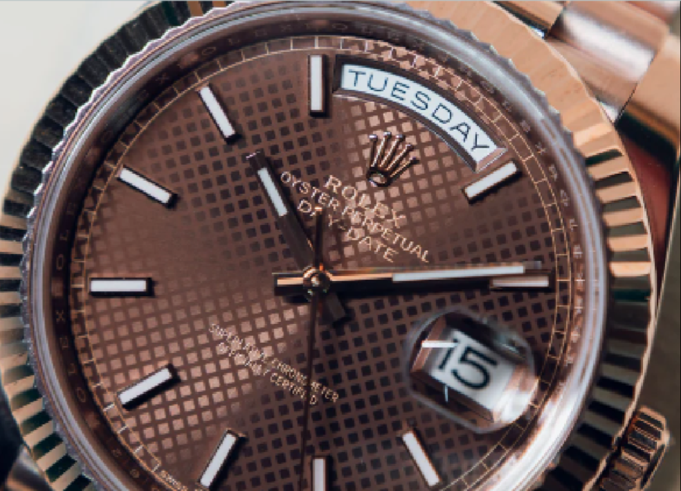Rose gold watch with detailed face and brand logo